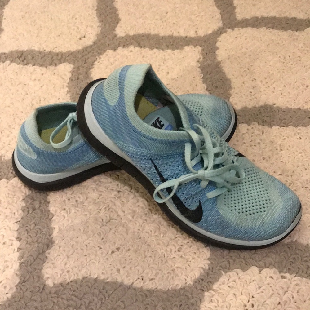 Nike blue and black fly knit running shoes.